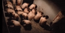 a group of people are standing in a room .