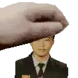 a man in a suit and tie is being held over his head by a hand .