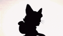 a silhouette of a cartoon character with a star on his head and a ponytail .