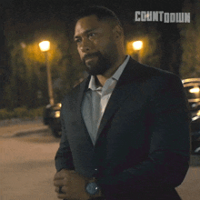 a man in a suit with the word countdown on the bottom