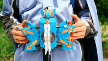 a person is holding a toy that looks like a butterfly