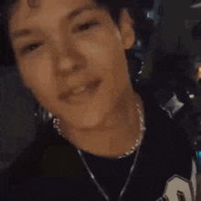 a young man is blowing a kiss with his hands .