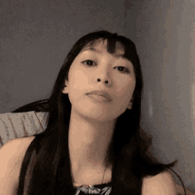 a close up of a woman 's face with her eyes closed