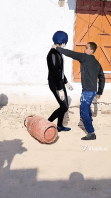 a man standing next to a cylinder that says vaggie