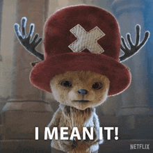 a stuffed animal wearing a hat with antlers and the words i mean it