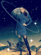 a woman in a blue dress stands in front of a planet with a ring around it