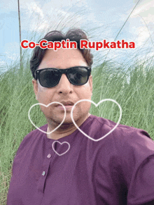 a man wearing sunglasses and a purple shirt has the name co-captain rupkatha above his head