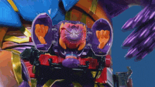 a toy with a purple head is being thrown up in the air