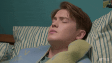 a man laying in bed with a netflix logo on the bottom right
