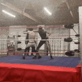 two wrestlers are in a ring with a sign that says tomorrow