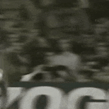 a soccer player wearing a number 9 jersey is kicking a soccer ball in the air .
