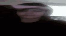 a close up of a person 's face with a blurred background .