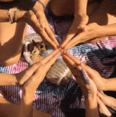 a group of people putting their hands in a circle