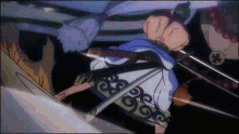 a man in a kimono is holding a sword in his hand while fighting another man .