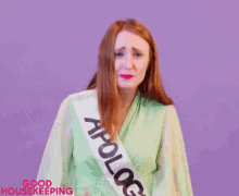 a woman wearing a sash that says " good housekeeping "