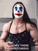 a woman wearing a clown mask says " oh hey there sweetcheeks "