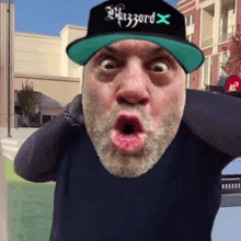 a man wearing a hat that says blizzard x on it