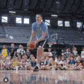 a basketball player wearing a shirt that says ' bruins ' on it dribbles the ball