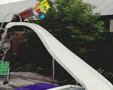 a person is going down a slide with a sign that says ' ff ' on it