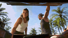 a man and a woman are looking out the back of a car