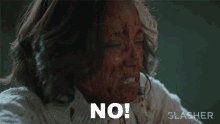 a woman with blood on her face is screaming no