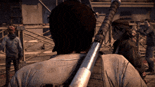 a man holding a baseball bat looks at a woman