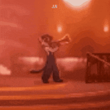 a man in overalls is playing a trumpet in a dark room .