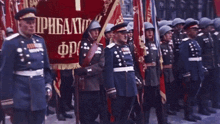 a group of soldiers are holding flags and a banner that says " прибалти " on it