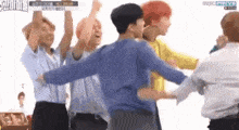 a group of young men are dancing together in a circle .