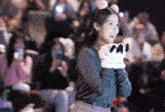 a girl wearing a headband and gloves with panda paws on them
