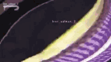 a close up of a purple and yellow striped item with the words bint salman 2 on it .