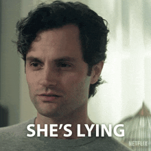 a close up of a man 's face with the words she 's lying below him