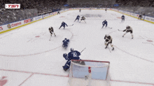 a hockey game is being played on a rink sponsored by tim hortons