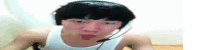 a man wearing headphones and a white tank top is making a face .