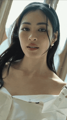 a close up of a woman 's face with the word elle on the bottom right