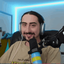 a man wearing headphones and a t-shirt that says the original