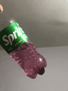 a bottle of sprite with purple liquid inside