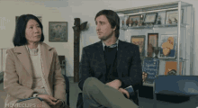 a man and a woman sit in a waiting room with movieclips.com on the bottom of the screen