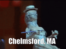 a lizard wearing a top hat and holding a wand with the words chelmsford ma on the bottom