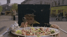 a man is holding a gun in front of a pizza