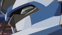 a close up of a robot 's face with a green eye