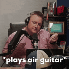 a man playing a guitar in front of a microphone with the words " plays air guitar " on the bottom