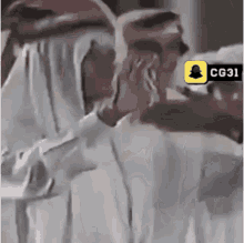 a group of men are standing next to each other and one of them is wearing a white veil .