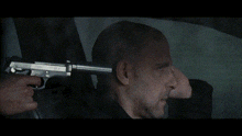 a close up of a man 's face in a rear view mirror