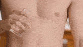 a person 's bare feet are standing on a wooden floor with water coming out of them .