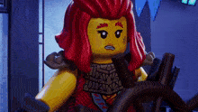 a lego girl with red hair is holding a wheel