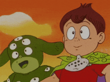 a boy in a green cape holds a green monster with many eyes