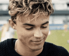 a close up of a man 's face with a sweater on