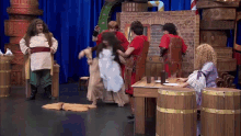 a group of people dressed in costumes are standing around a table