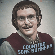 a man with glasses and a mustache is wearing a sweater that says yeah counting some numbers